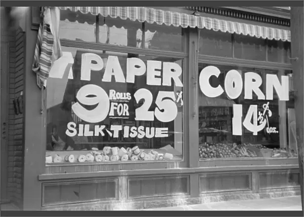 A sign in grocery store window PAPER - 9 rolls for 25 cents
