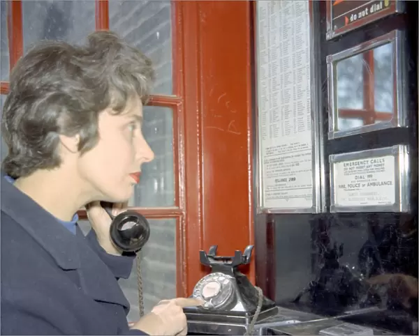 Example of a woman dialling 999