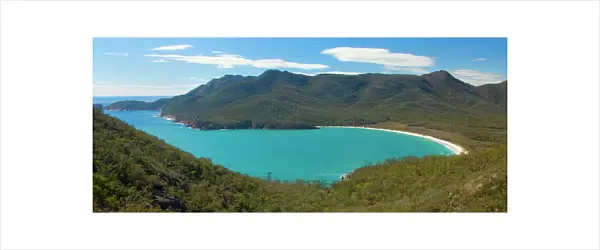 Wineglass Bay - beautiful, turquoise coloured Wineglass Bay and surrounding mountains seen from Wineglass Bay Lookout. This is one of the most famous natural landmarks on Tasmania - Freycinet National Park, Tasmania, Australia