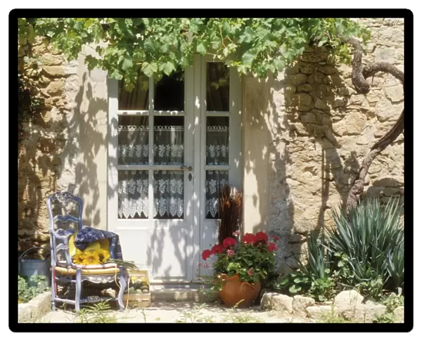 France Blue chair & vine & net-curtained white door, Provence