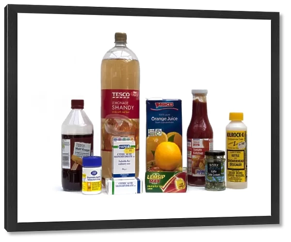 Display of household items containing acids including vinegar aspirin orange citric acid tomato sauce lemsip - UK