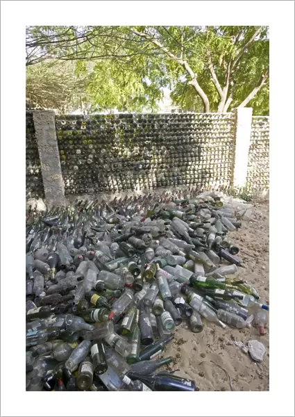 Recycling - wall built out of wine bottles. Lamu, Kenya