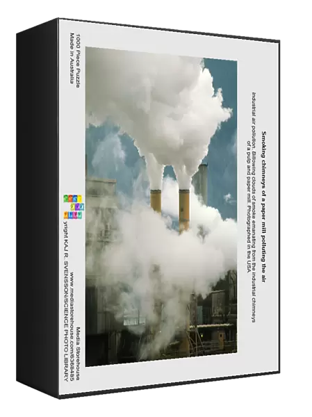 Smoking chimneys of a paper mill polluting the air