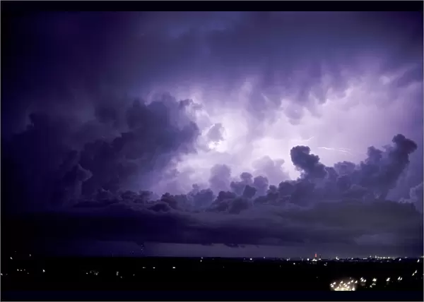 Lightning. In-cloud and cloud-to-air lightning illuminating a thundercloud
