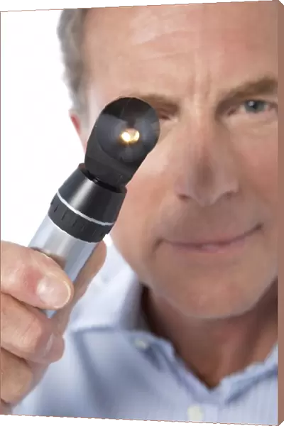 Doctor holding an otoscope