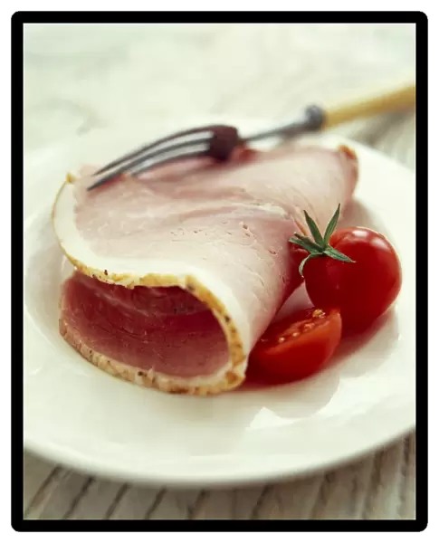 Ham on a plate with tomatoes