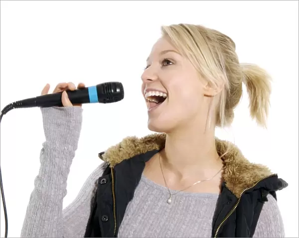Karaoke. MODEL RELEASED. Karaoke. Woman singing into a microphone