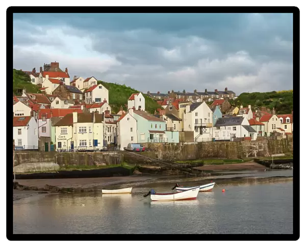 Harbour wall and the village of Staithes, North Yorkshire National Park, Yorkshire, England, United Kingdom, Europe