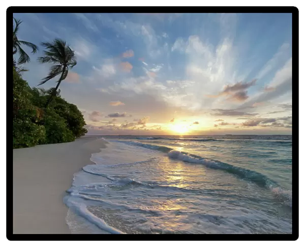 Sunrise over the Indian Ocean from a deserted beach in the Northern Huvadhu Atoll, Maldives, Indian Ocean, Asia