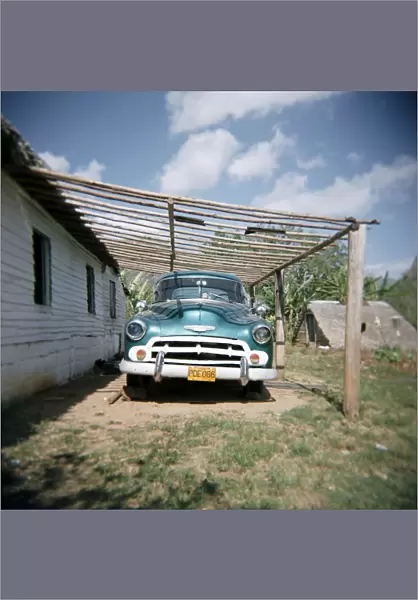 Old green American car on farm near Vinales, Cuba, West Indies, Central America