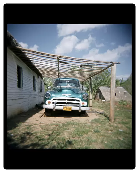 Old green American car on farm near Vinales, Cuba, West Indies, Central America