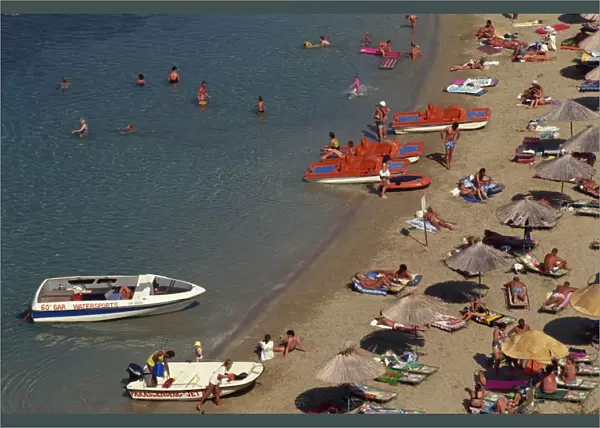 Aerial view over boats and people on a crowded beach
