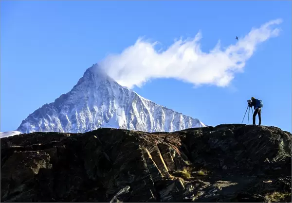 Photographer in action in front of the snowy Weisshorn, Zermatt, Valais, Pennine Alps