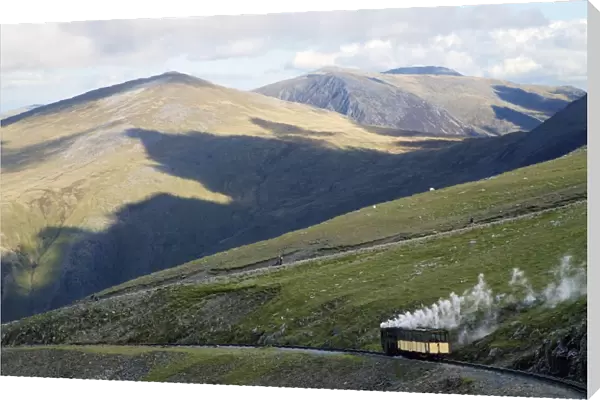 Steam engine and passenger carriage on trip down Snowdon Mountain Railway, Snowdonia National Park