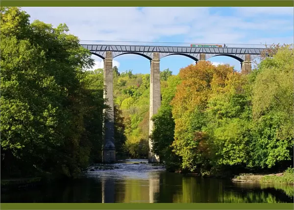 Narrowboat crossing the River Dee in autumn on the Pontcysyllte Aqueduct, built by Thomas Telford