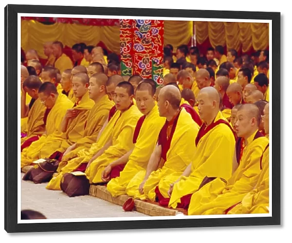 Monks sitting together inside Kargyupa gompa (monastery)
