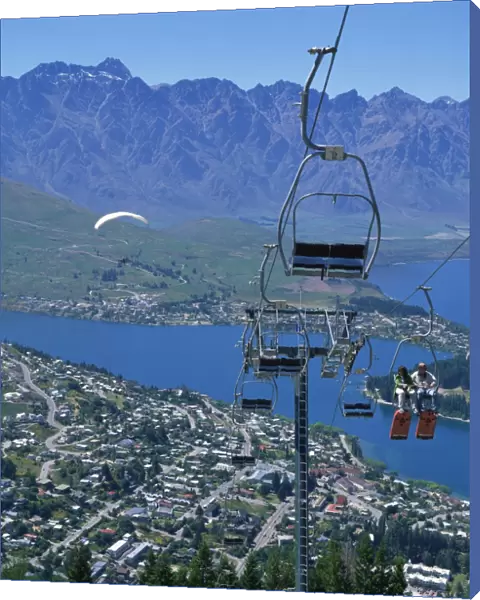 Tourists on a chair lift with Lake Wakatipu