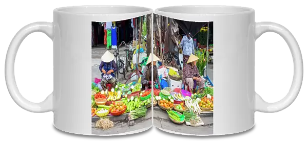 Women selling vegetables at the central market in Hoi An, Quang Nam Province, Vietnam