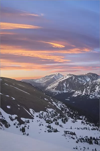 Orange clouds at dawn above Longs Peak