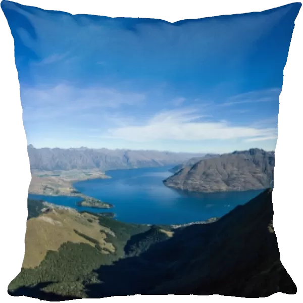 Steep sharp mountains, a deep blue lake, and mountain town in Queenstown, Otago, South Island