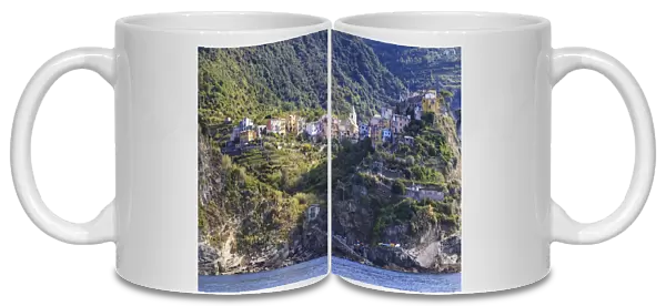 Colourful houses and cliffs atop rocky promontory, Corniglia, Cinque Terre, UNESCO