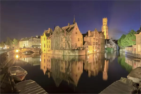 The medieval City Centre, UNESCO World Heritage Site, framed by Rozenhoedkaai canal at night