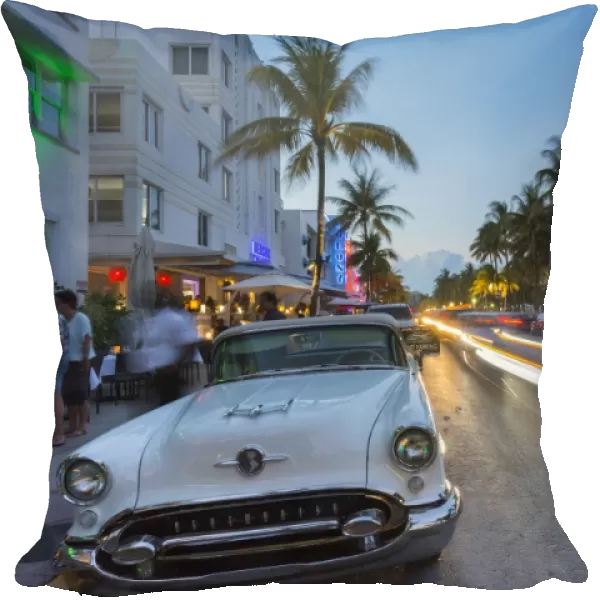 Ocean Drive restaurants, vintage car and Art Deco architecture at dusk, South Beach