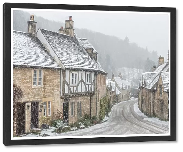 Looking down the quintessential English village of Castle Combe in the snow, Wiltshire
