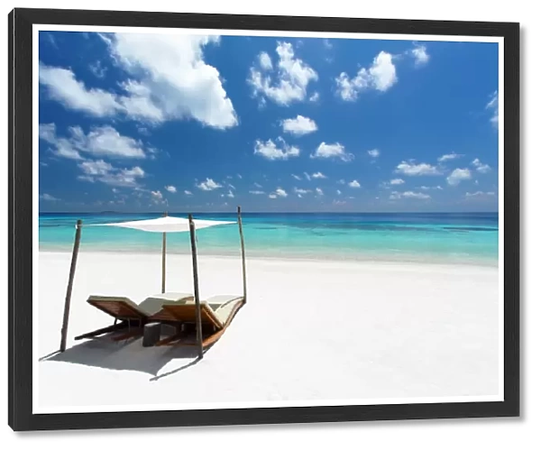Lounge chairs on tropical white sandy beach, The Maldives, Indian Ocean, Asia