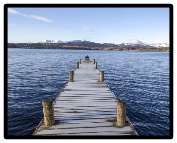 Frost covered jetty at the north end of Windermere near Ambleside, with rugged snow