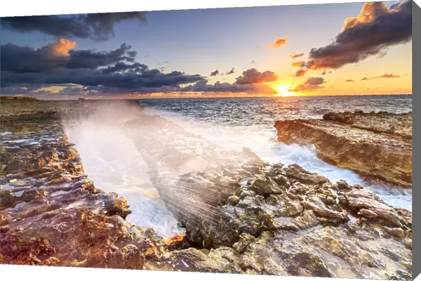 Waves crashing on cliffs at sunrise, Devils Bridge, Antigua, Antigua and Barbuda