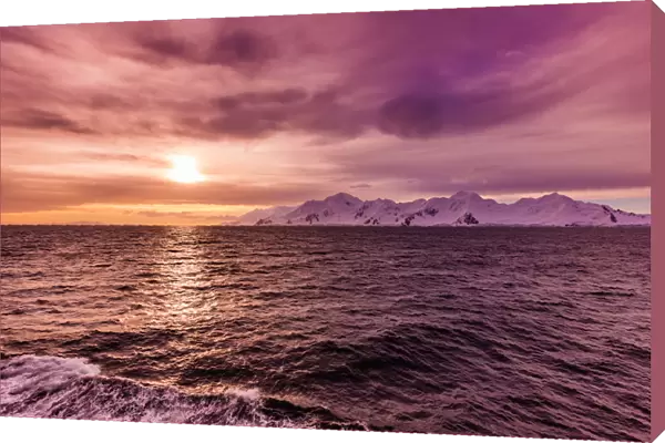Sunset and a scenic view of the glacial ice and floating icebergs in Antarctica