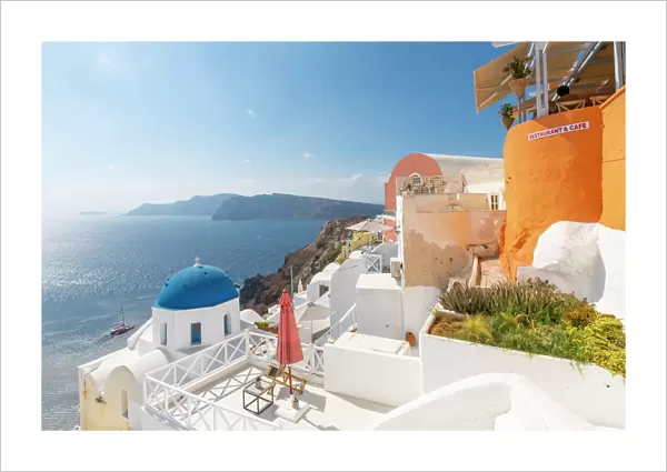 View of blue domed church from cafe in Oia village, Santorini, Aegean Island, Cyclades Island