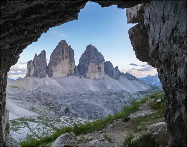 Three Peaks of Lavaredo seen through a rock cave. Sesto Dolomites, Trentino Alto Adige, Italy