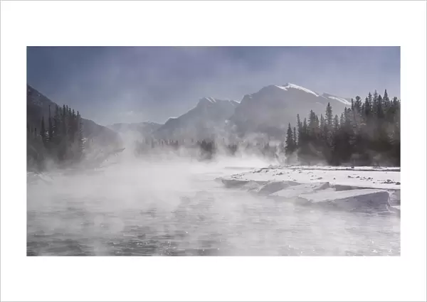 Mist rising off the waters of the Bow River in sub-zero winter weather, Canmore, Alberta