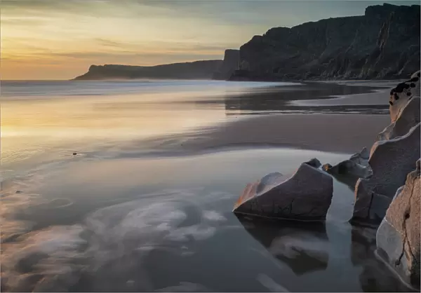 Sunset over a deserted Mewslade Bay in Gower in winter, South Wales, United Kingdom