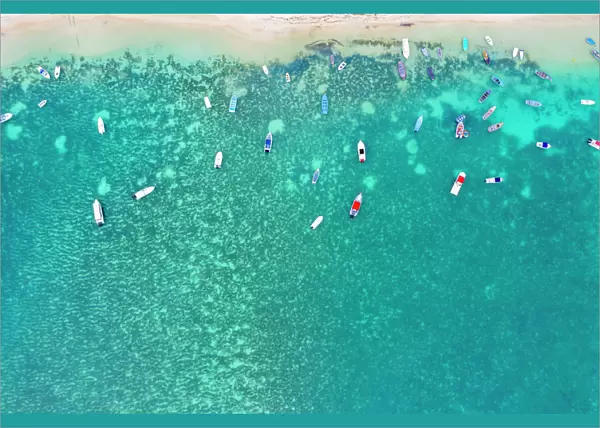 Aerial by drone of boats in the turquoise water of lagoon front of Mont Choisy beach
