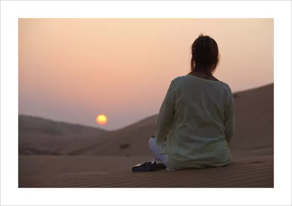 Woman with Bible in the desert, Abu Dhabi, United Arab Emirates, Middle East