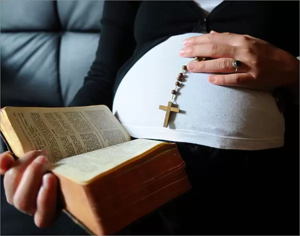 Christian pregnant woman reading the Bible, Paris, France, Europe