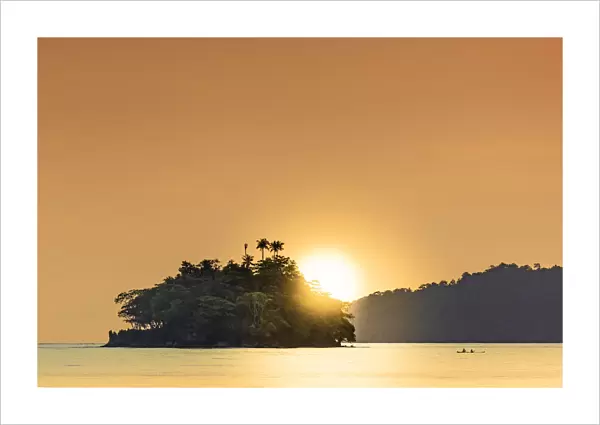 The sun setting behind islets in the Banda archipelago, Banda, Maluku, Spice Islands