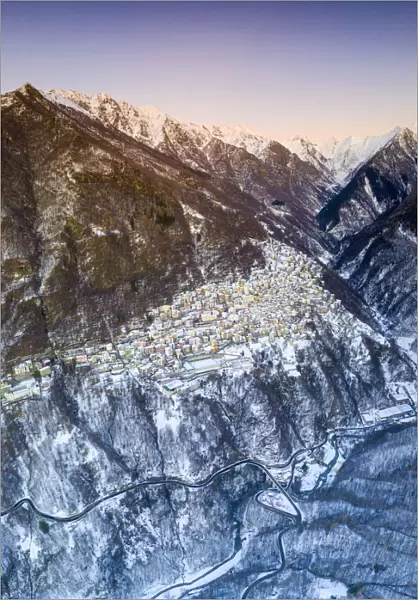 Aerial panoramic by drone of Premana village during winter dusk, Valsassina