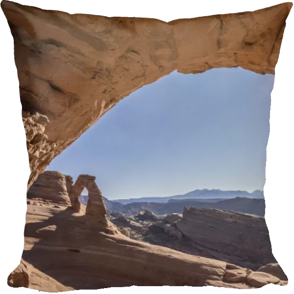 View of Delicate Arch through Frame Arch with sunburst, Arches National Park, Utah