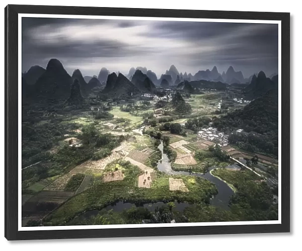 Long exposure of Yangshuo mountains with dark clouds, Yangshuo, Guangxi, China, Asia