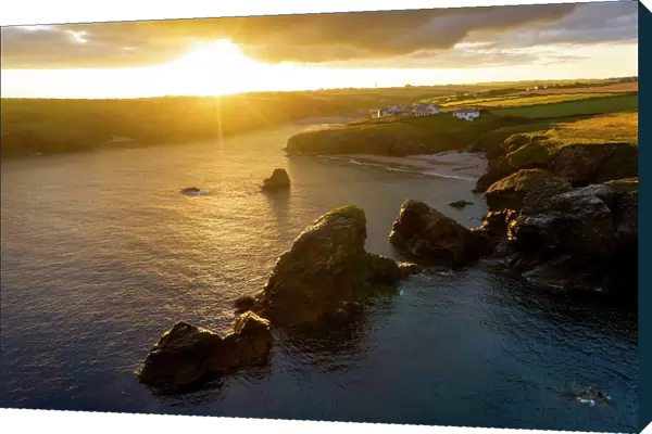 Summer sunrise over Porthcothan Bay on the North Cornwall coast, Cornwall, England