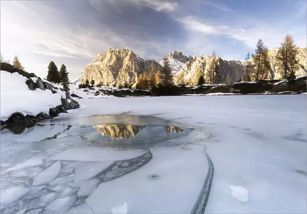 Lagazuoi mountain mirrored in the icy lake Limides at dawn, Ampezzo Dolomites