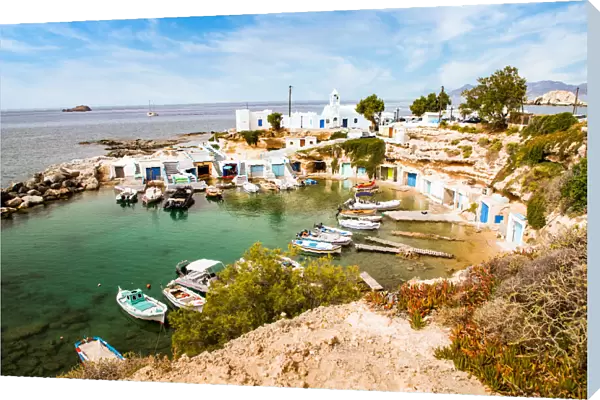 View over fishing harbour with boats and colourful boat houses, Mandrakia, Milos