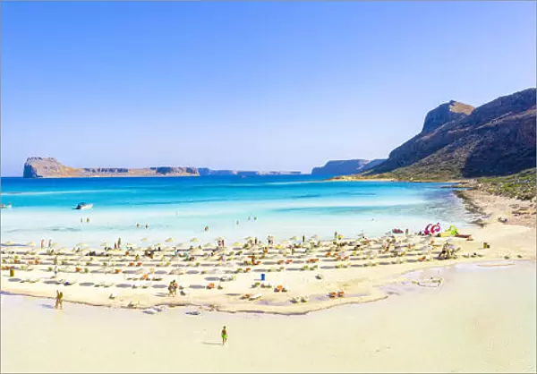 People sunbathing on idyllic white sand beach, Balos, Crete, Greek Islands, Greece