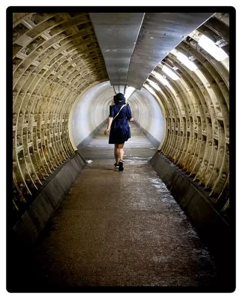 Woman walking through the Greenwich foot tunnel, Greenwich, London, England, United Kingdom, Europe
