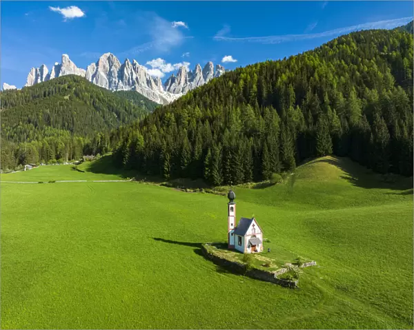 Aerial view of the Odle and iconic chapel of St. John in Ranui in spring, St. Magdalena, Funes Valley, Dolomites, South Tyrol, Italy, Europe