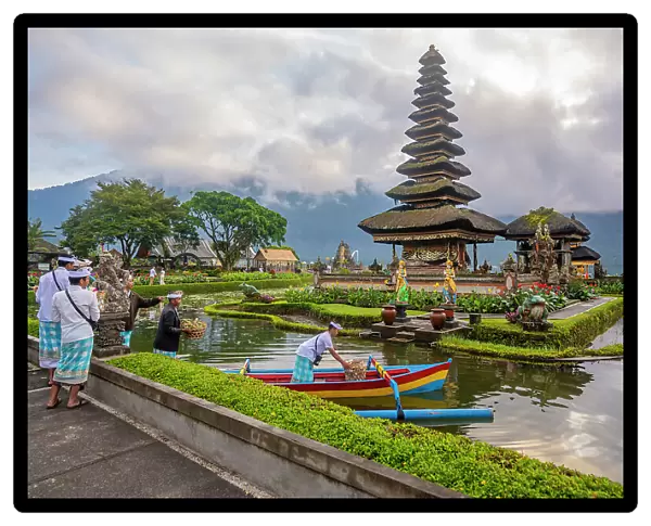 View of offerings being made at Ulun Danu Beratan temple on Lake Bratan at sunrise, Bali, Indonesia, South East Asia, Asia
